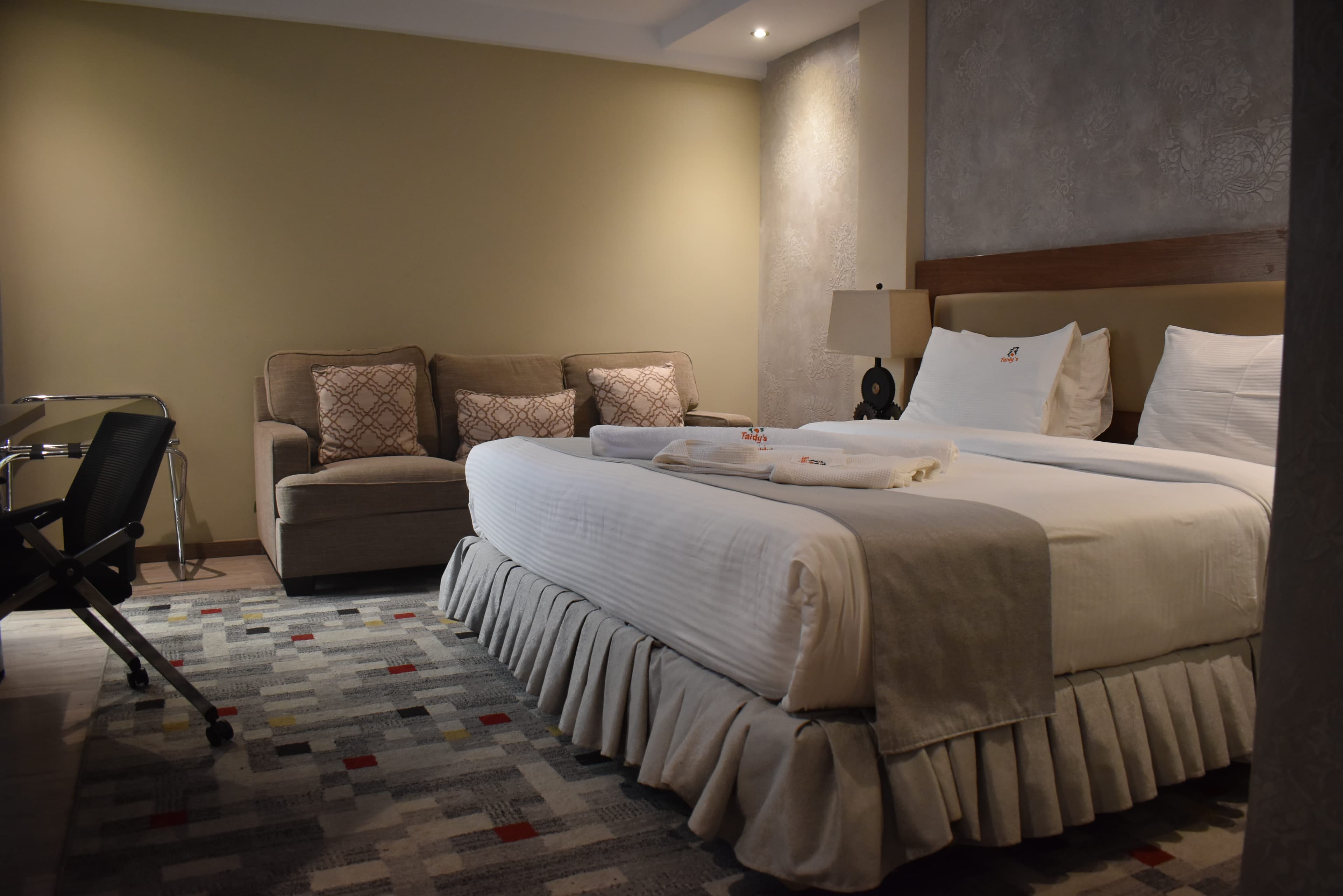 A welcoming suite with soft bedding and warm lighting at Taidy's Nakuru